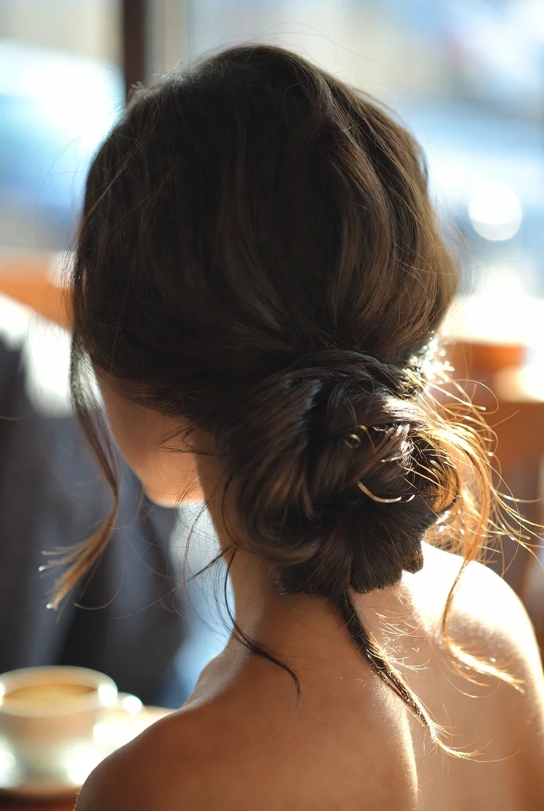 Messy Low Bun with Loose Strands